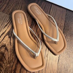 Brand new.  Never been worn.
Gold accent flip flops